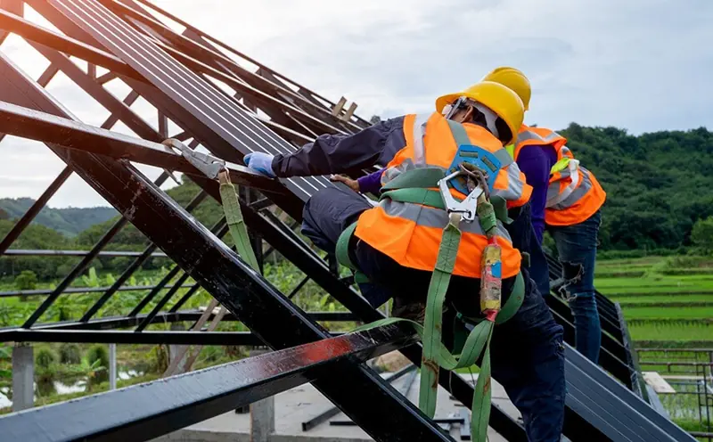 Worker in a safety harness working at height